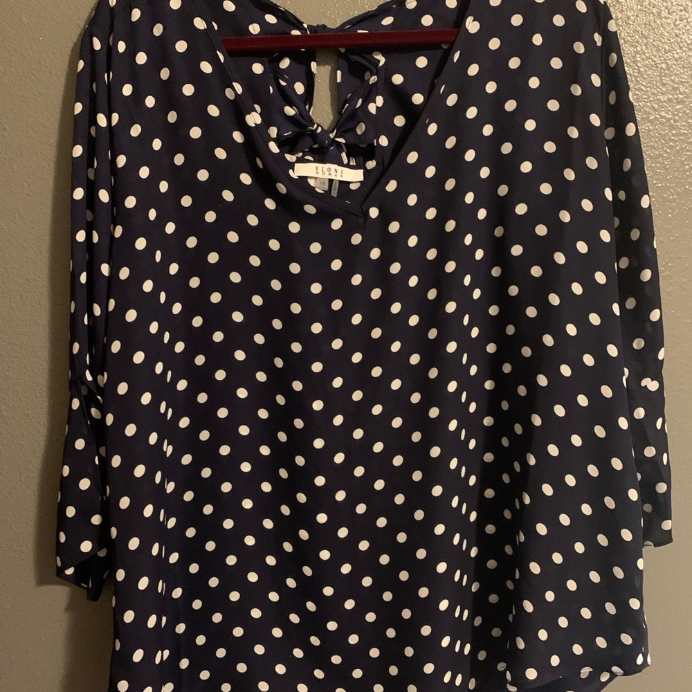 Suomi Woman Navy polka dot blouse.